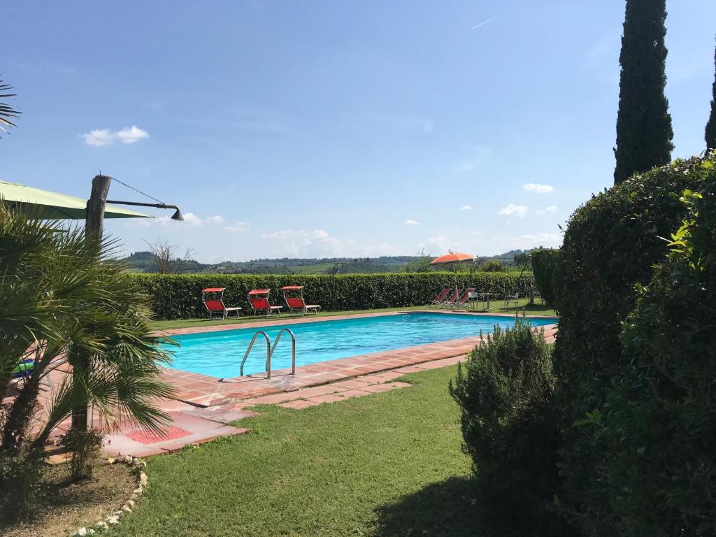 a swimming pool with a slide in a yard at Podere Remignoli in San Gimignano