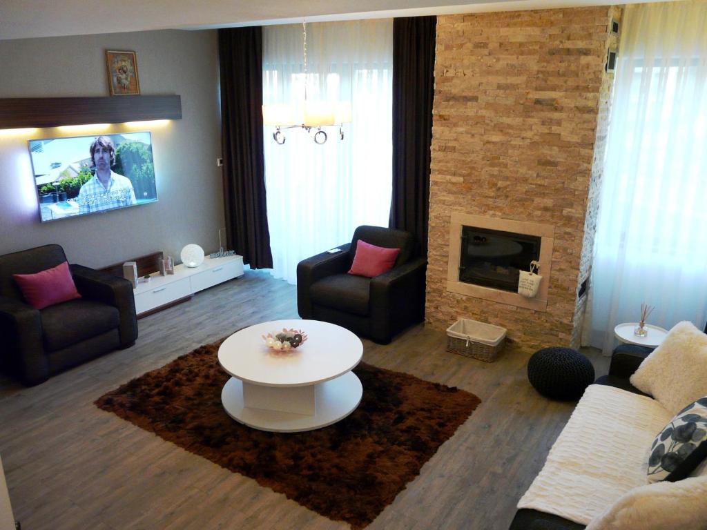 a living room with a couch and a table at Silver Mountain Apartment A32 - 3 rooms 3 bathrooms in Poiana Brasov