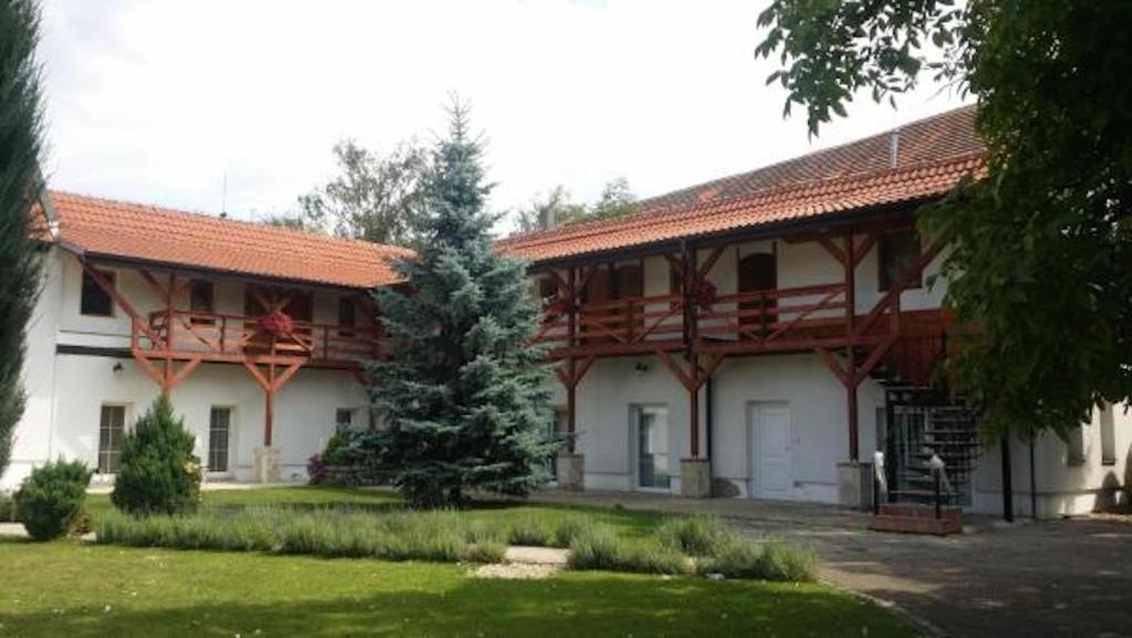 a large white building with a red roof at Green Club in Tursko