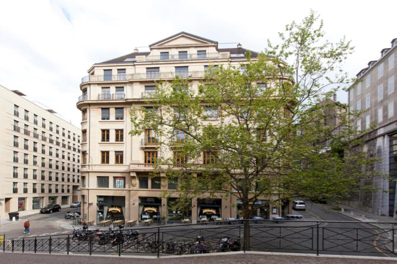 un gran edificio con bicicletas estacionadas frente a él en Hotel Central, en Ginebra