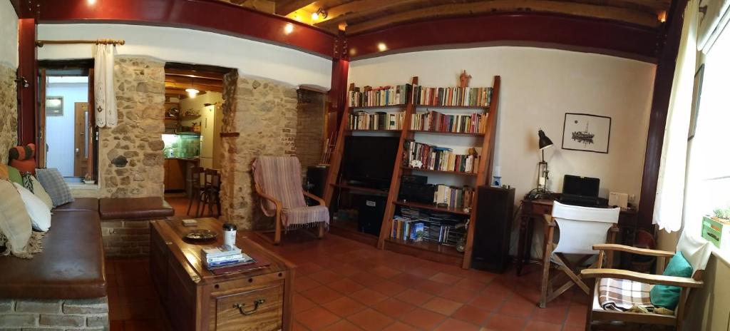 a living room with a couch and a book shelf at Old town Heraklion apartment in Heraklio Town