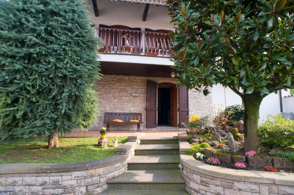 a house with a staircase in front of a yard at B&B Aria Di Lago in Paratico