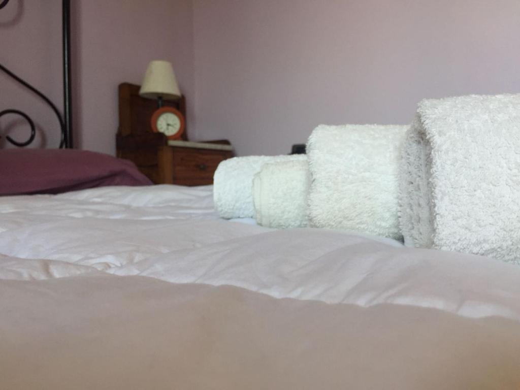 a white bed with a white pillow on top of it at Alex Room Airport in Elmas