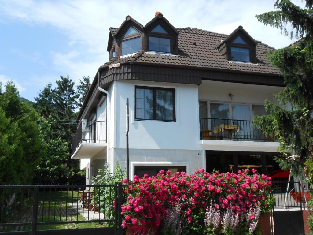 a house with pink flowers in front of it at Nagy Vendégház in Badacsonytomaj