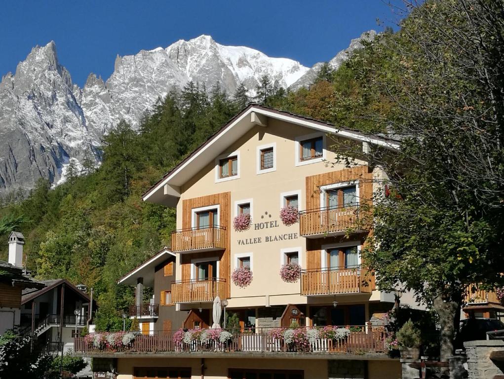 a building in front of a mountain at Hotel Vallée Blanche Courmayeur in Courmayeur