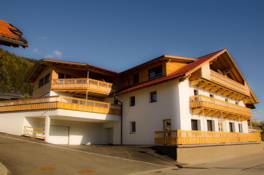 a building with wooden balconies on top of it at Römerstraße 10 KG, Appartement Inntal in Innsbruck