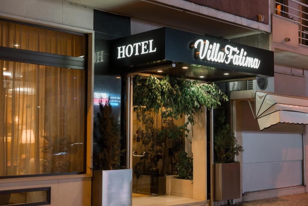 a store front of a hotel with a sign on it at Villa Fatima Hotel by Umbral in Fátima