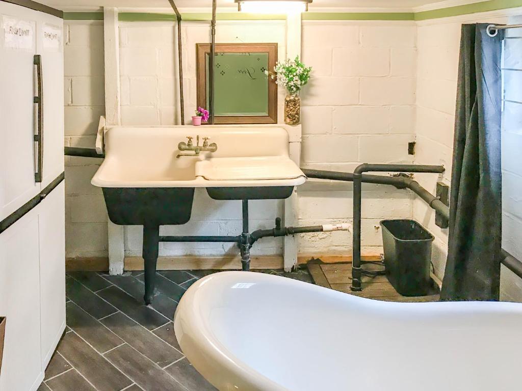 a bathroom with a sink and a bath tub at Co-ed Dorm with Fantastic Patio! in Ewing