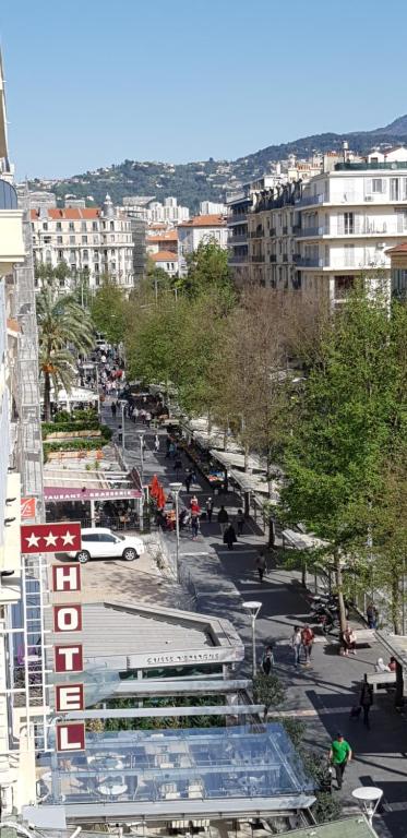 a view of a city street with people and buildings at Hôtel Annexe in Nice