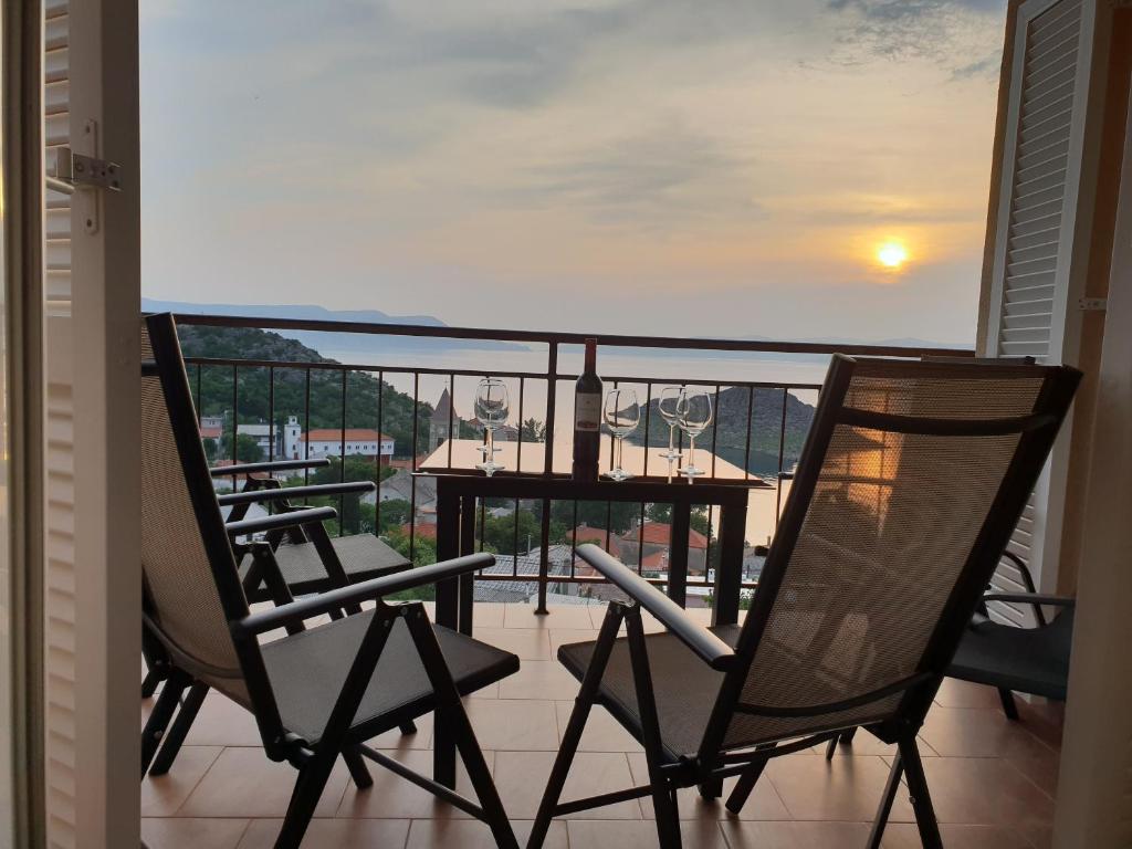 a balcony with chairs and a table with a view at Slavica apartments 2 in Sveti Juraj