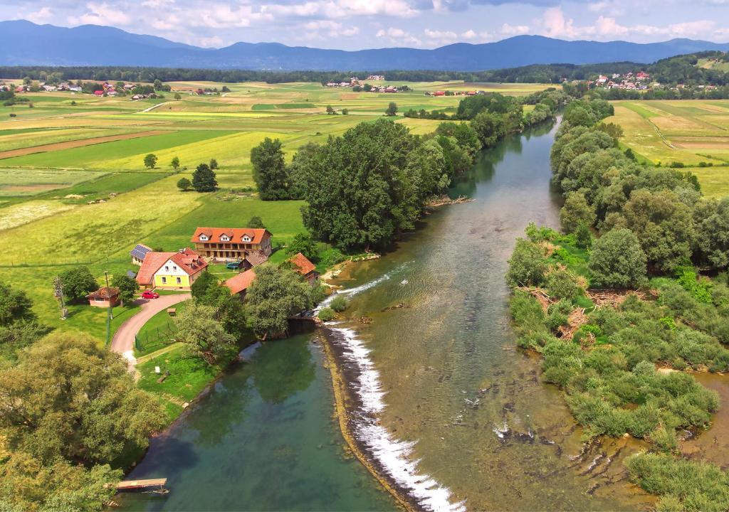 an aerial view of a river with a house at Fortun Estate - apartmaji ob reki Kolpi in Metlika
