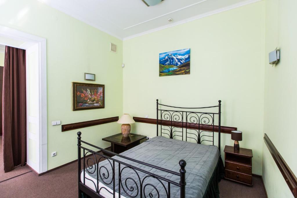 a bedroom with a black bed with a night stand at Luxury central two bedroom apartment in Lviv