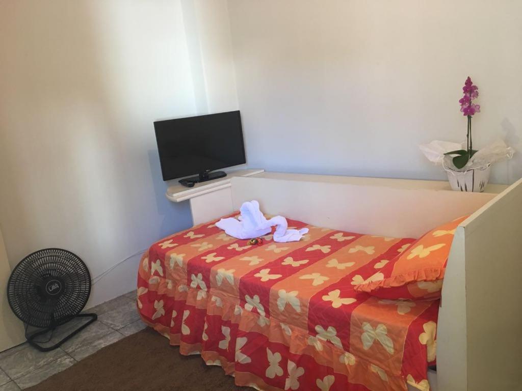 a room with a bed with a towel on top of it at Residencias JAC in Paraguaçu Paulista