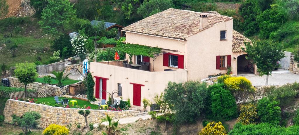 a house on the side of a hill with a fence at B&B L'Estuve provencale in Bargemon