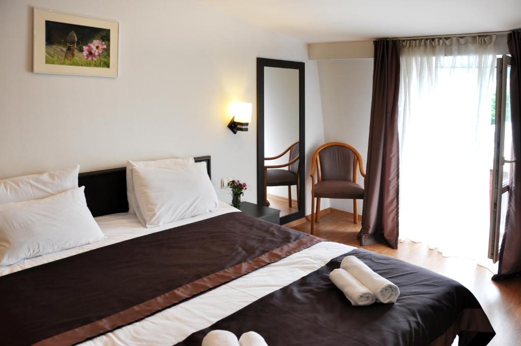 Postel nebo postele na pokoji v ubytování Hotel Corner
