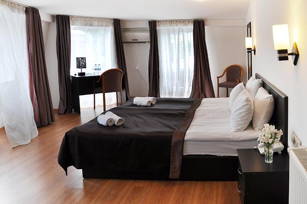 1 dormitorio con 1 cama grande y escritorio en Hotel Corner, en Tiflis