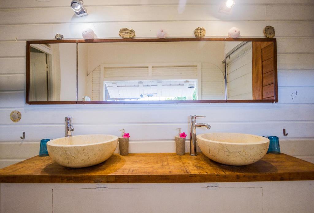 a bathroom with two sinks and a mirror at Carre Royal in Deshaies