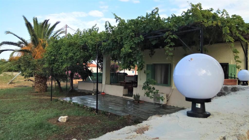 a house with a large white sphere in front of it at Country Village House in Skala Mistegnon