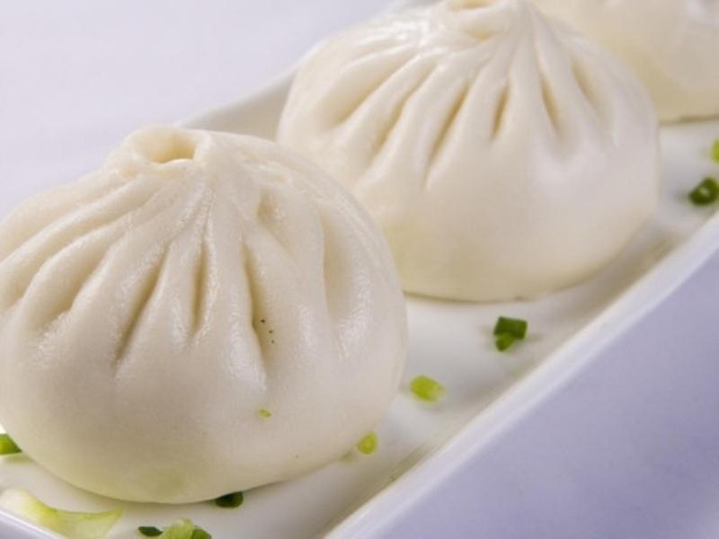 two pieces of white food on a white plate at GreenTree Inn Yangzhou Jiangdu Xiaoji Town South Zhongxing Road Express Hotel in Xiaoji