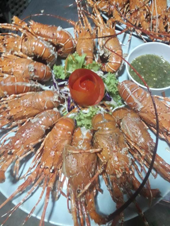 a plate of lobster food with a tomato on it at JJ Beach Resort & JJ Seafood in Ko Phayam
