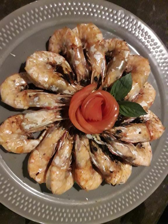 a plate of shrimp with a tomato on it at JJ Beach Resort & JJ Seafood in Ko Phayam
