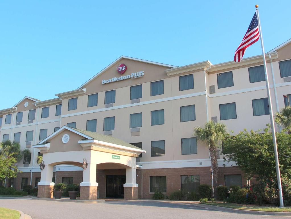 a hotel with an american flag in front of it at Best Western Plus Valdosta Hotel & Suites in Valdosta