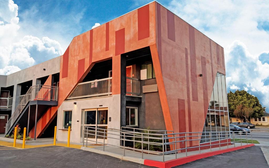 a building with an orange in a parking lot at Epic Hotel in Pico Rivera