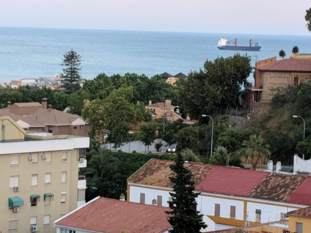 a view of a city with a boat in the water at Double room with brekfast "Wonderful views" in Málaga