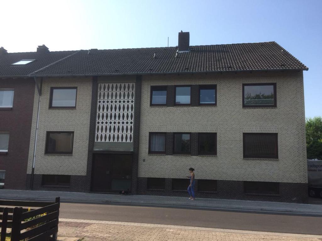 a woman walking in front of a building at Apartement "Sam" in Wilhelmshaven