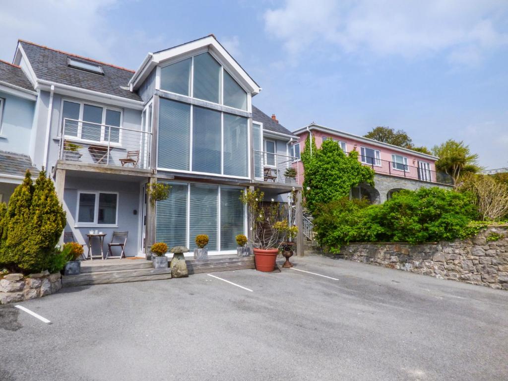 a house with a parking lot in front of it at The Mushroom House in Tenby
