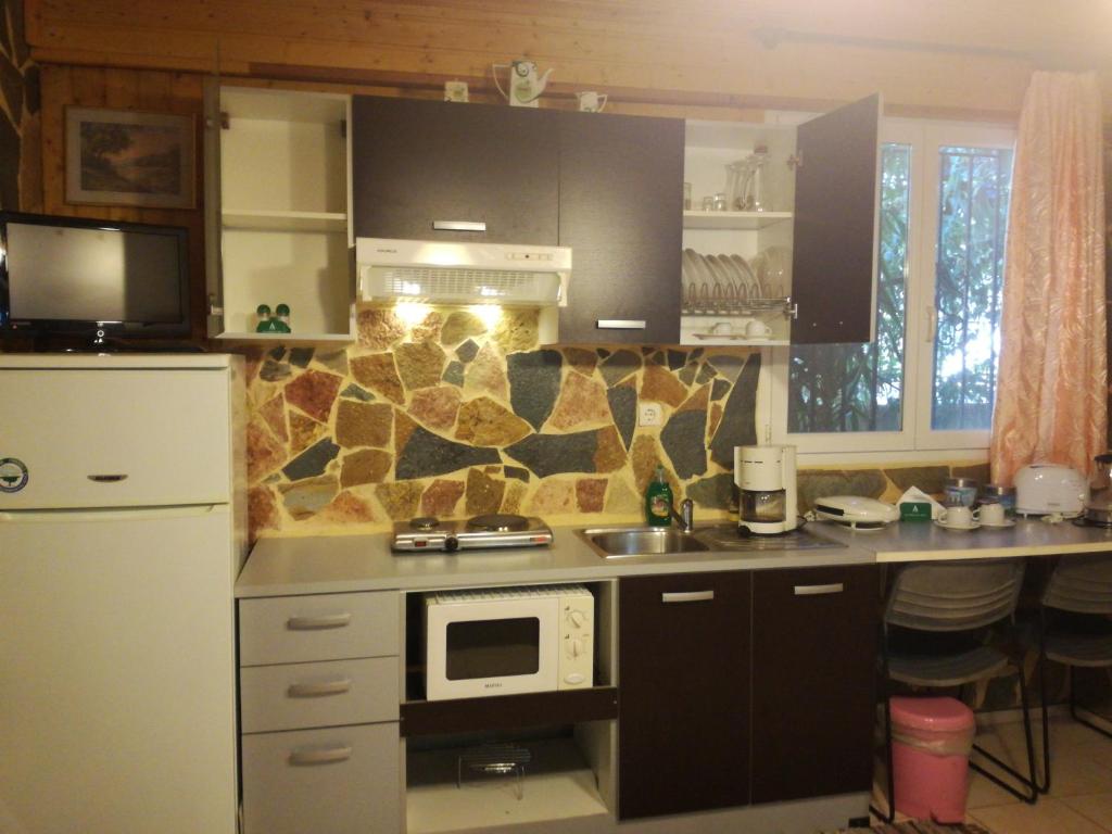 Kuchyň nebo kuchyňský kout v ubytování Apartments Zoumperi