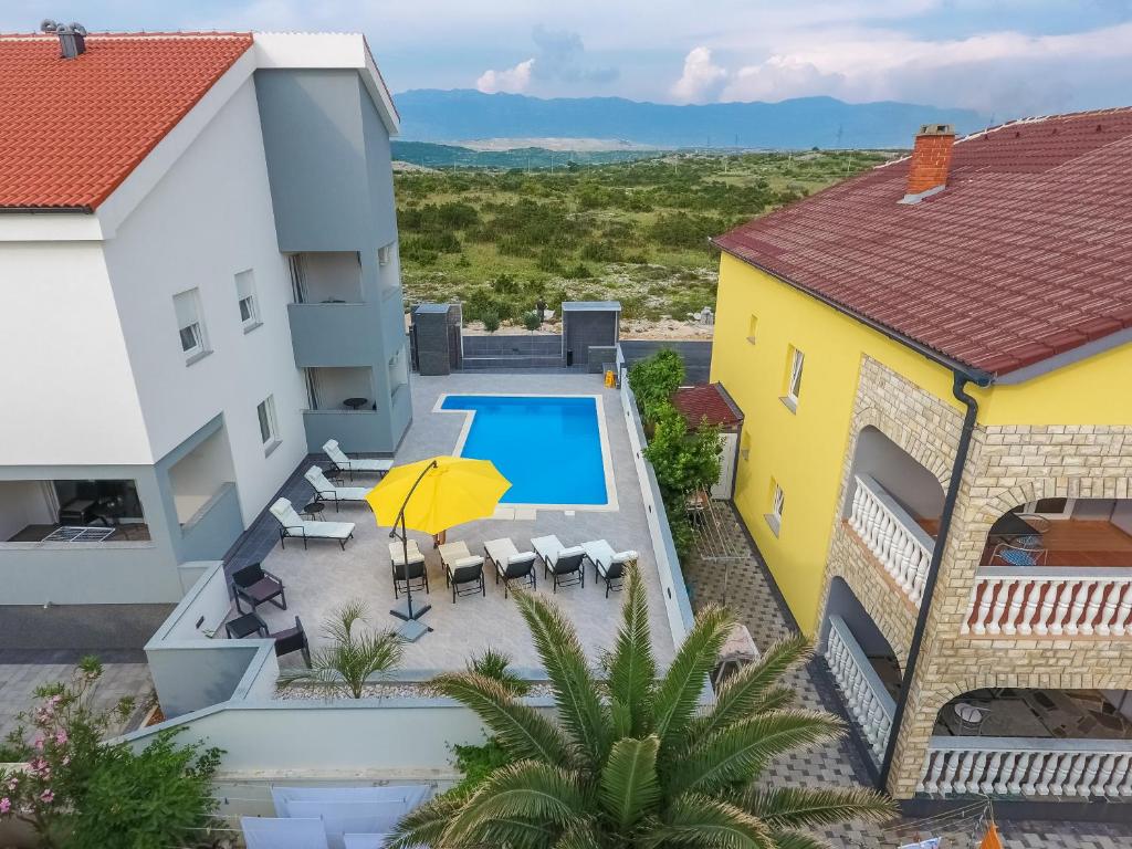 an aerial view of a villa with a swimming pool and a house at Privilege Pool Apartments in Novalja