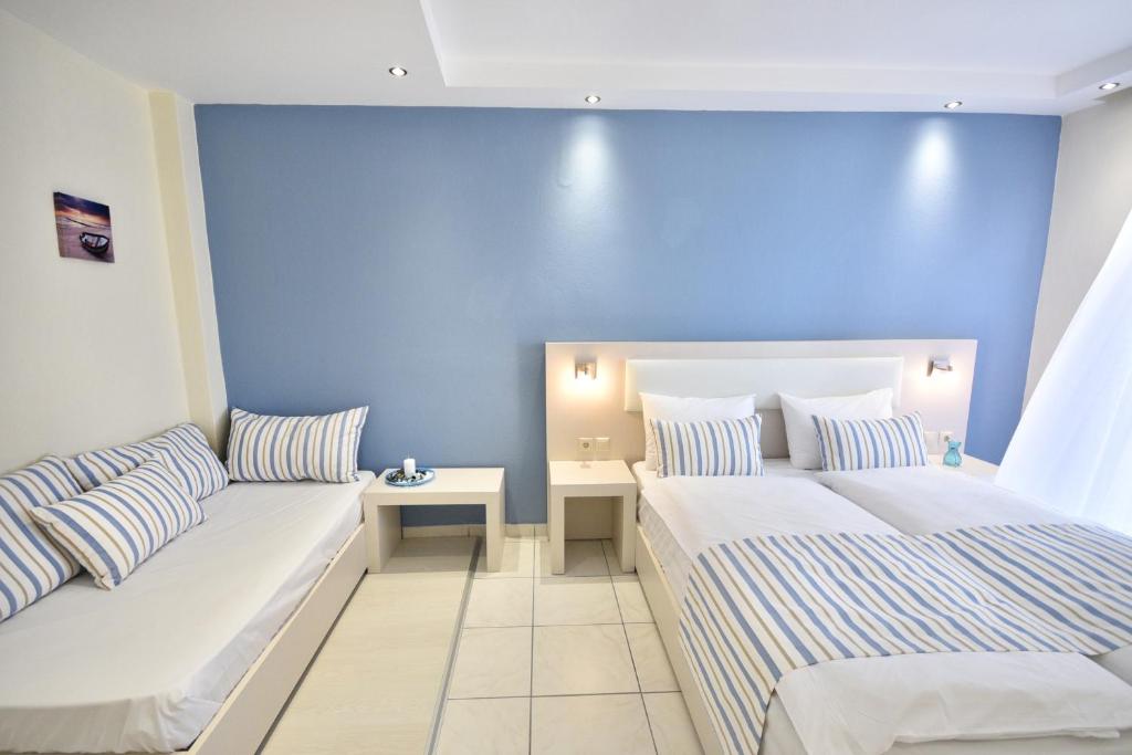 Postel nebo postele na pokoji v ubytování Blue Senses Hotel