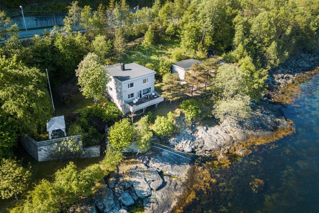 an aerial view of a house on the side of a river at Private House & Bungalow by the sea in Trondheim