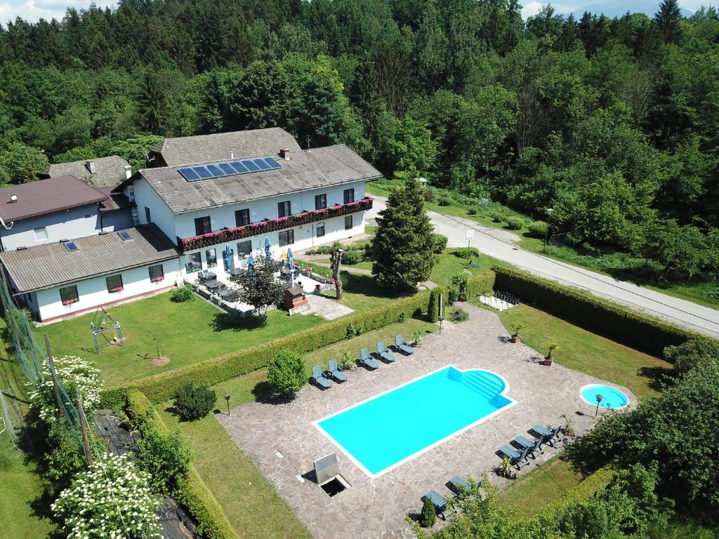 eine Luftansicht eines Hauses mit Pool in der Unterkunft Gasthof Waldwirt in Sankt Kanzian am Klopeiner See