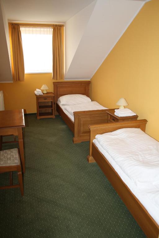 Postel nebo postele na pokoji v ubytování Hotel Bouček