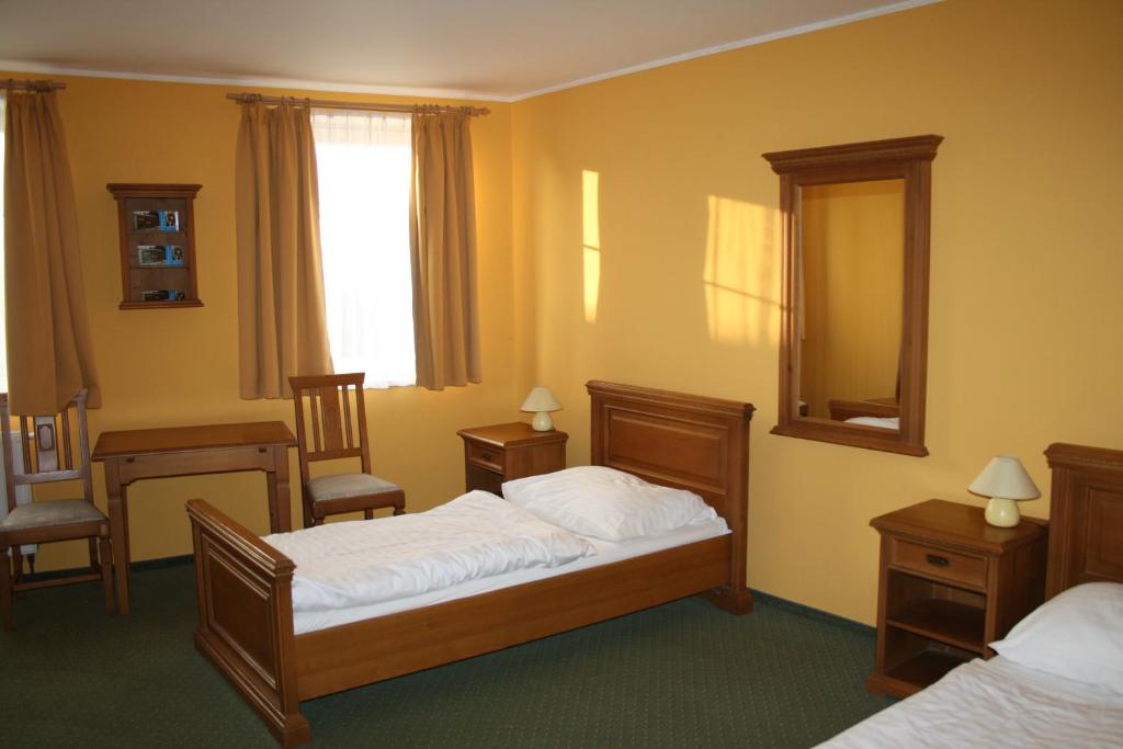 Postel nebo postele na pokoji v ubytování Hotel Bouček
