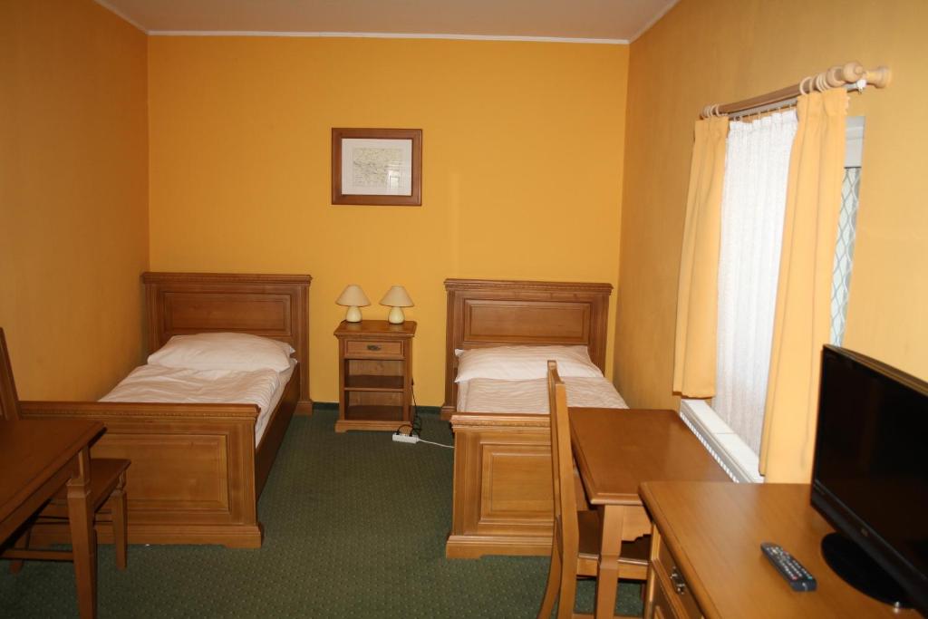 Postel nebo postele na pokoji v ubytování Hotel Bouček