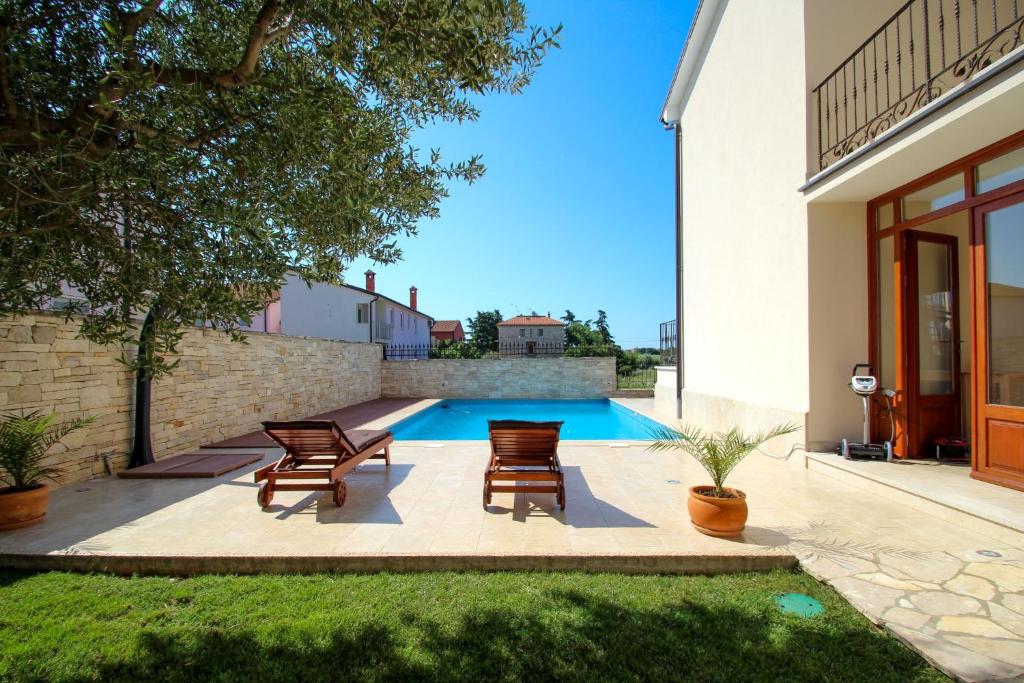 a patio with chairs and a swimming pool at Casa Rafael in Novigrad Istria