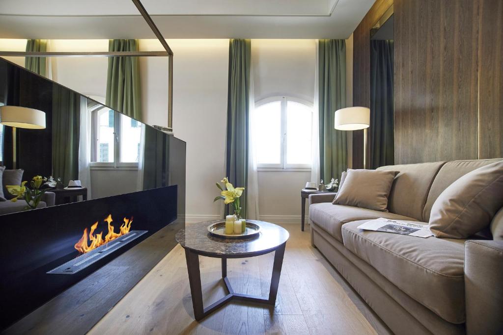 a living room with a couch and a fireplace at Messori Suites in Florence