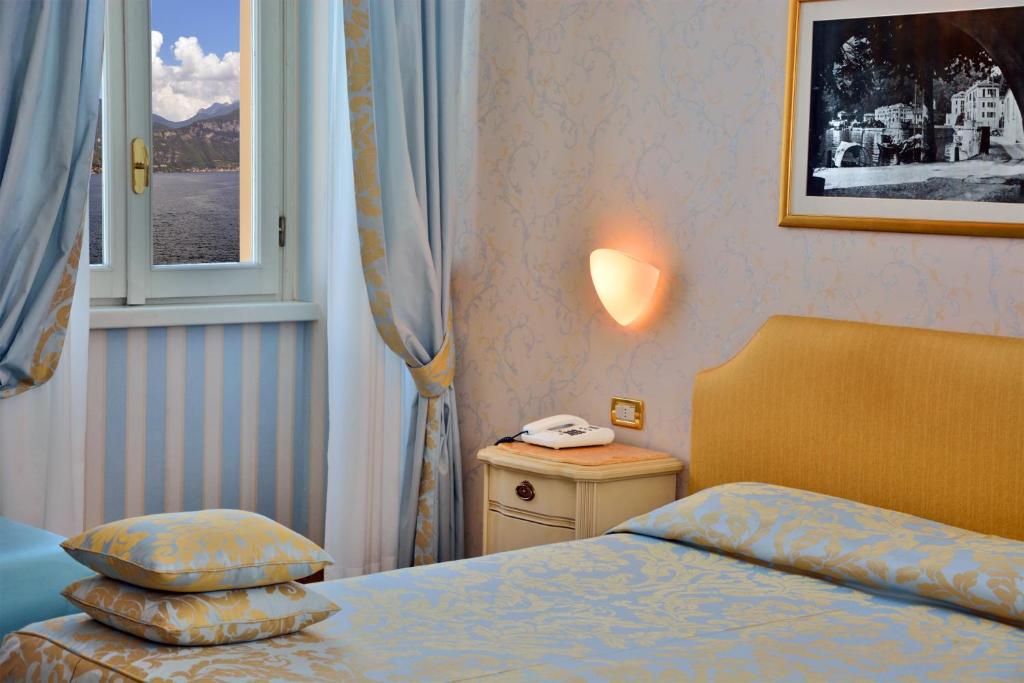Postel nebo postele na pokoji v ubytování Grand Hotel Menaggio
