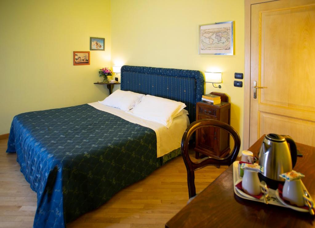 Postel nebo postele na pokoji v ubytování Hotel Ristorante Piccolo Chianti