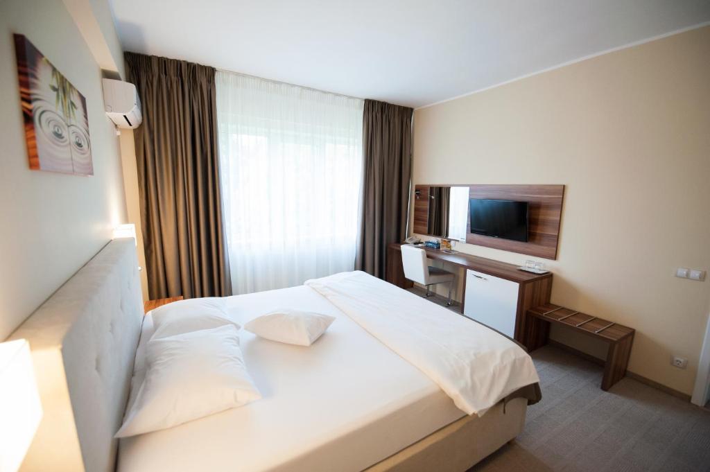 Postel nebo postele na pokoji v ubytování Bruxelles Guesthouse Craiova