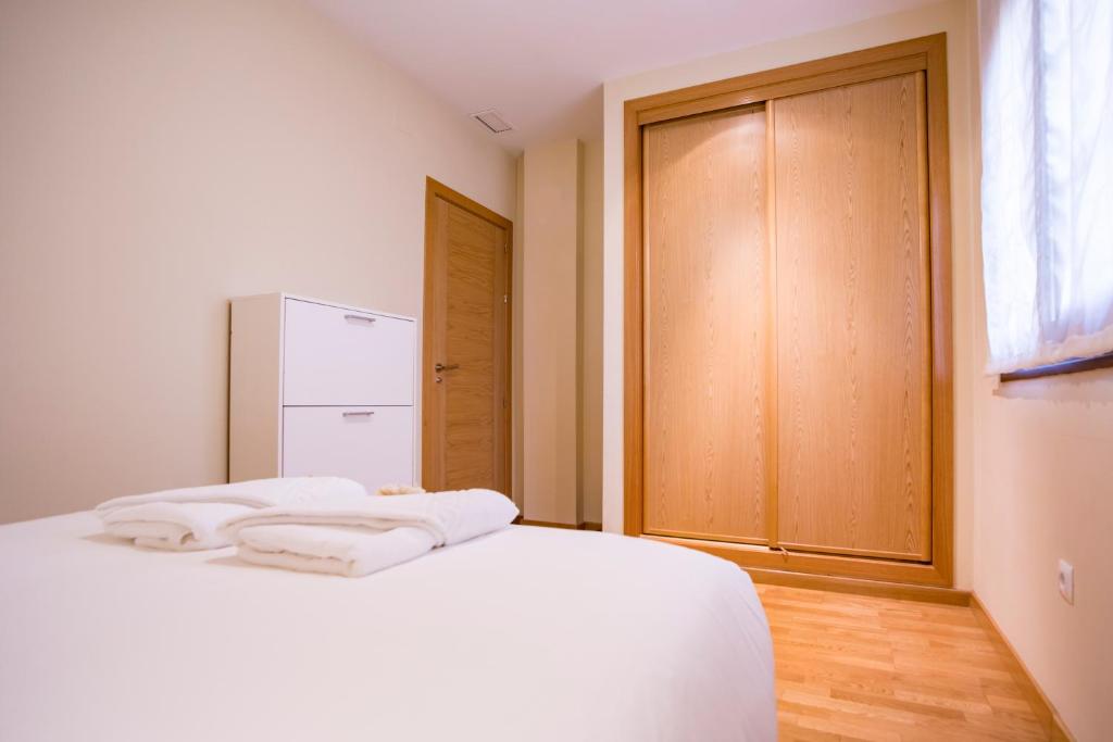 Posteľ alebo postele v izbe v ubytovaní Livemalaga Apartment & Parking