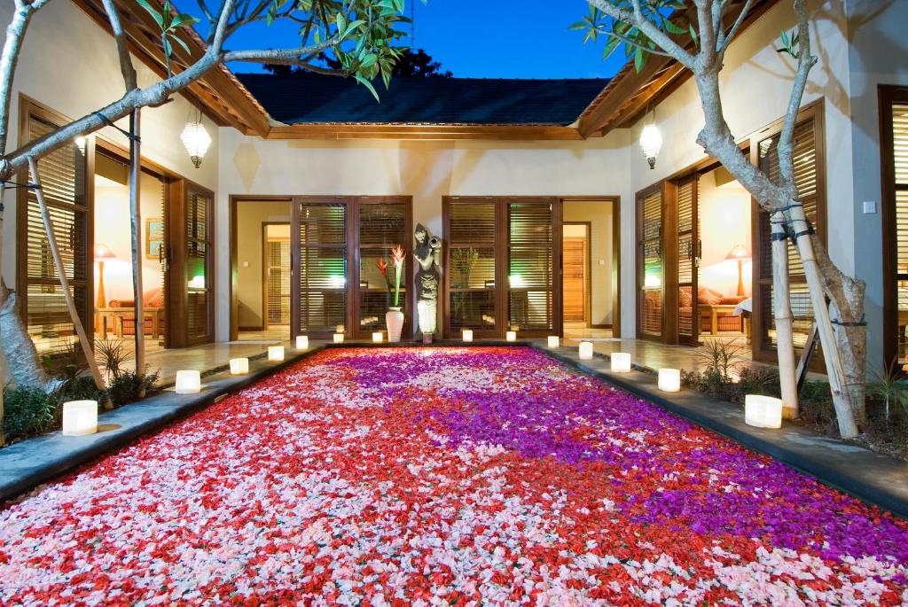 a large carpet of flowers on the floor of a house at Ajanta Villa in Sanur