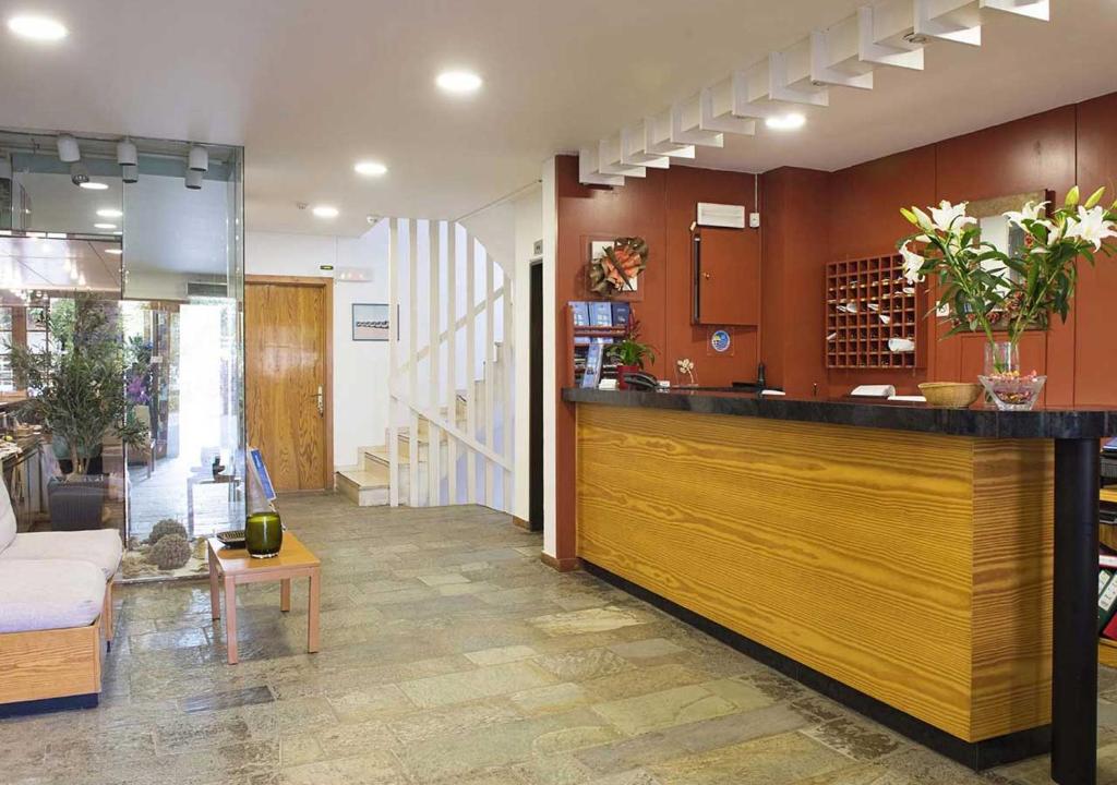 a lobby with a bar and a living room at Stefanakis Hotel & Apartments in Varkiza