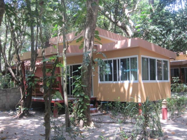 a small house in the middle of trees at JJ Beach Resort & JJ Seafood in Ko Phayam