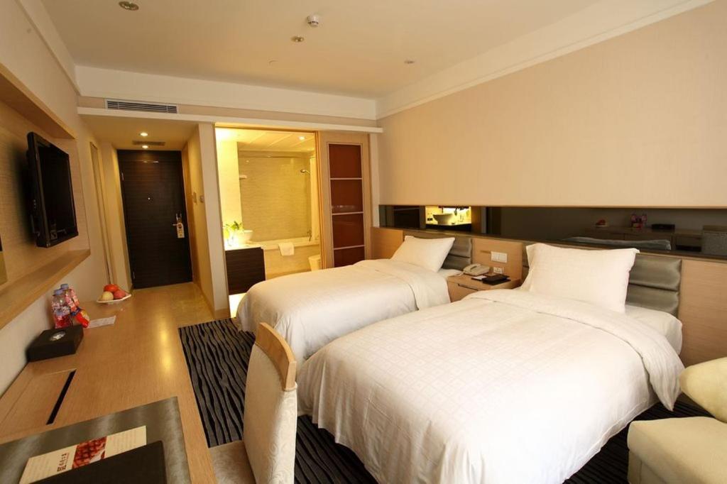 Postel nebo postele na pokoji v ubytování Shenzhen Shekou Honlux Apartment (Sea World)