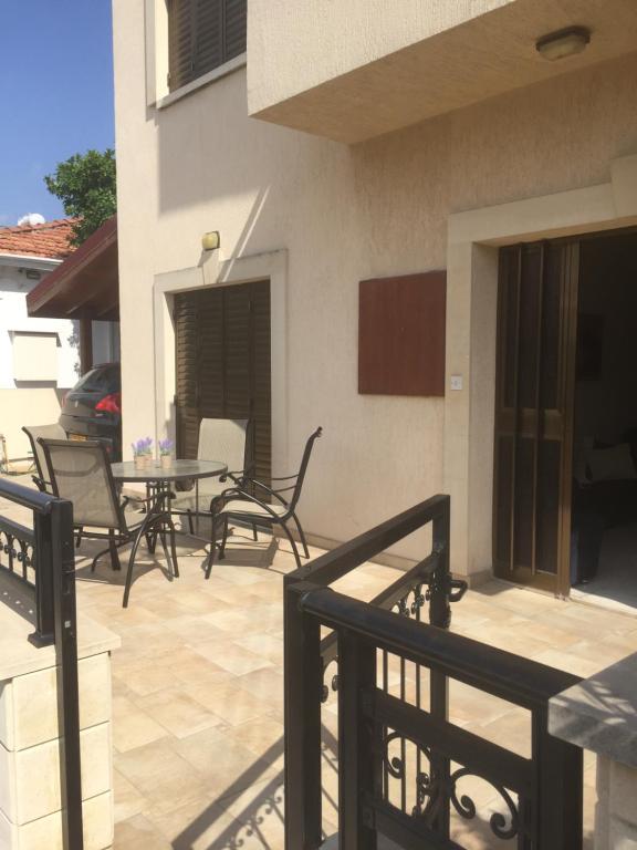 a patio with chairs and a table on a balcony at Artemis House in Limassol