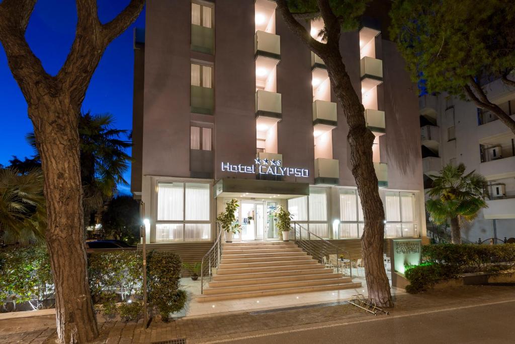 a hotel entrance with stairs in front of a building at Hotel Calypso- Rimini Marina Centro in Rimini
